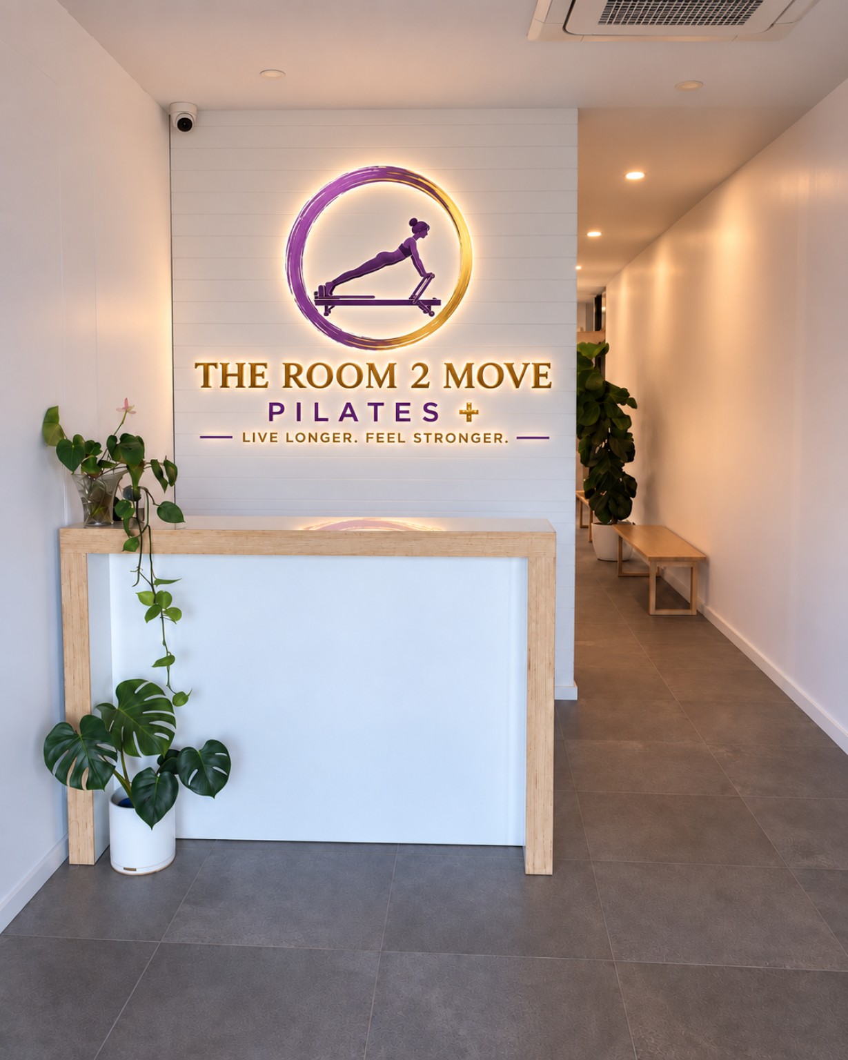 The Room 2 Move studio with the illuminated logo on the wall